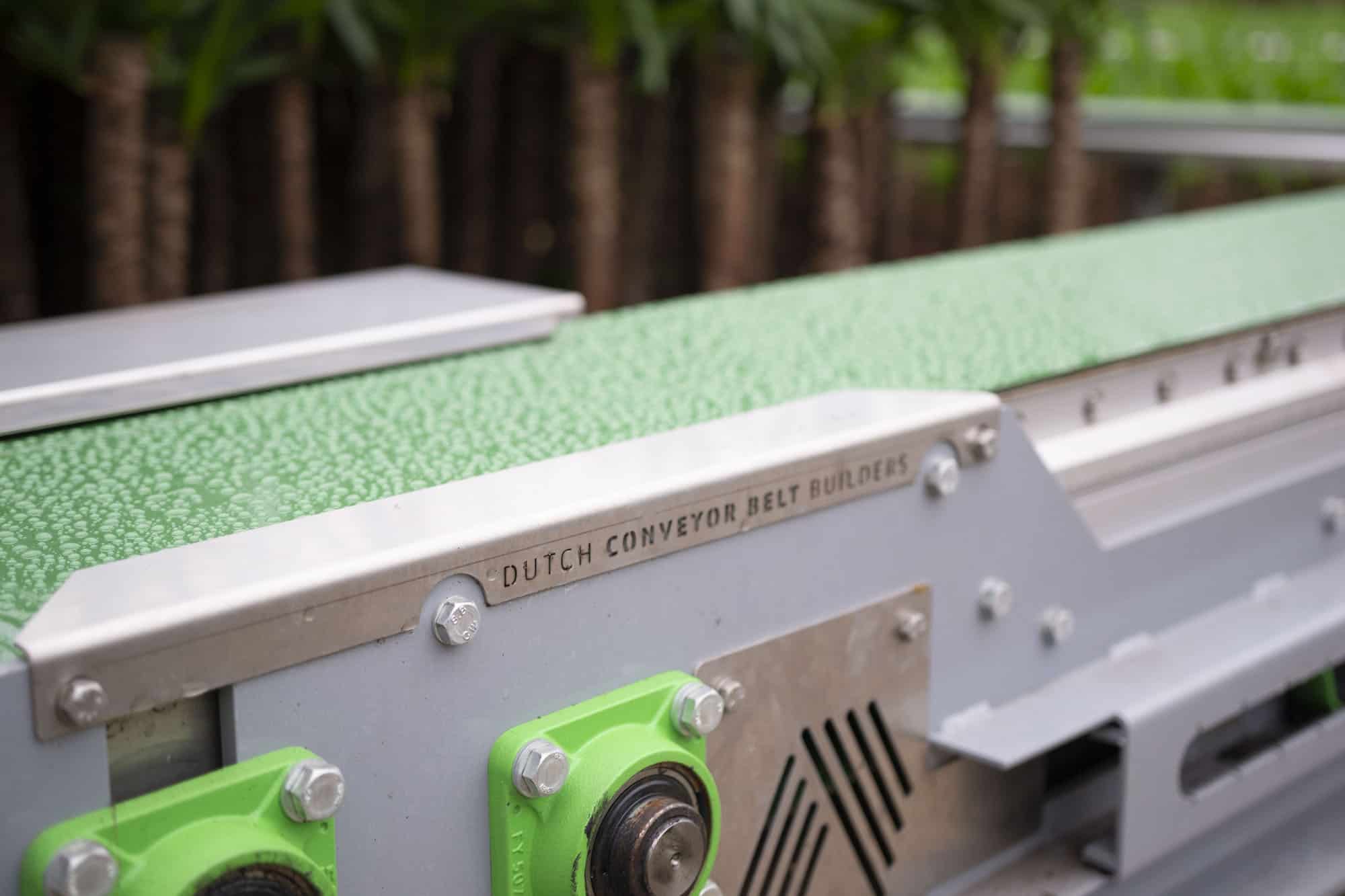 dutch conveyor belt builders show close up on a plant delivery mechanism